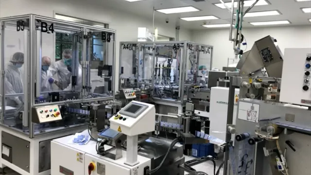 Gowned operators running automated assembly equipment in a medical device cleanroom