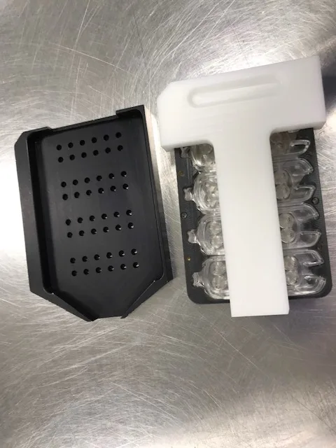 Manual cartridge filling tooling with black bead nest and white transfer guide